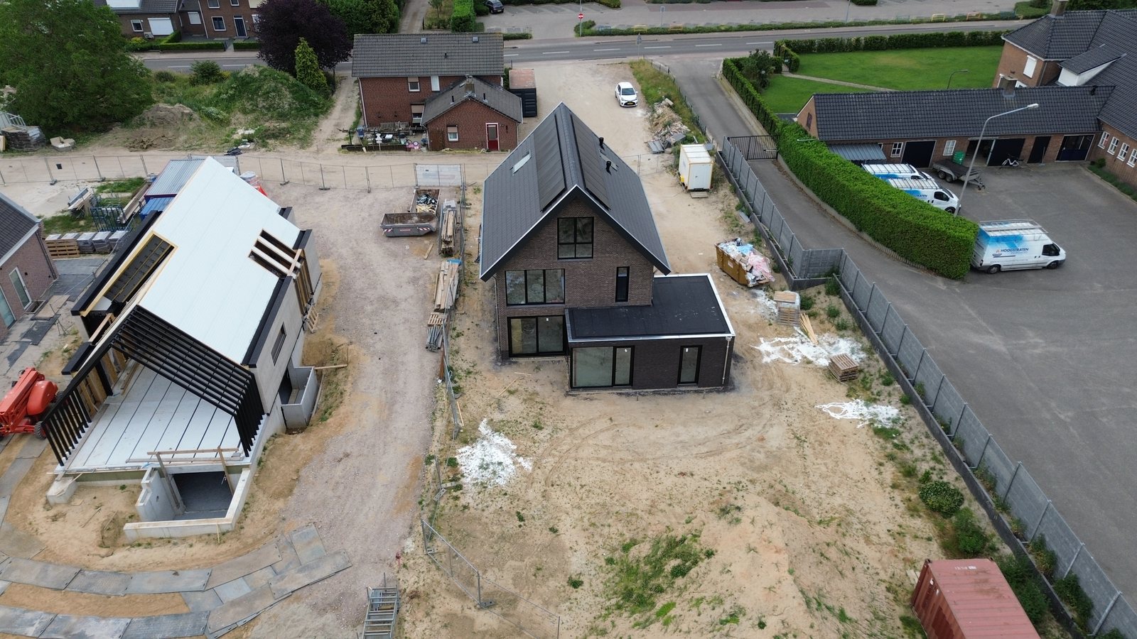 Luchtfoto van het bouwterrein met twee woningen in aanbouw